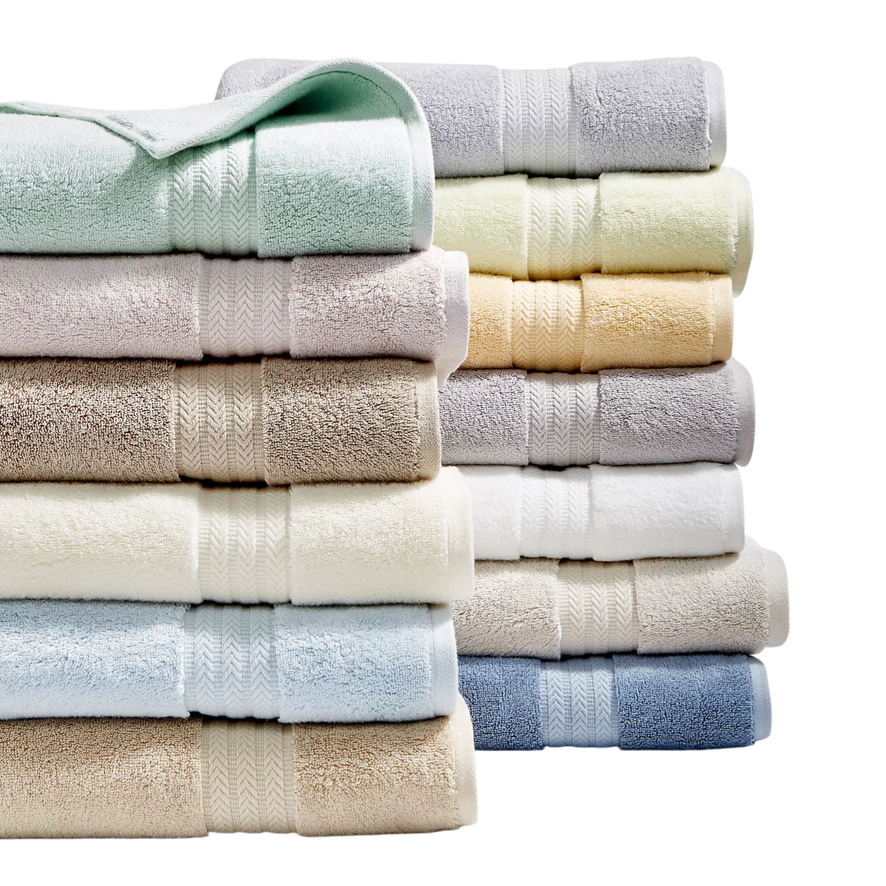 A variety of neatly stacked, colorful bath towels in pastel and neutral shades.
