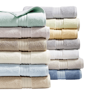 A variety of neatly stacked, colorful bath towels in pastel and neutral shades.