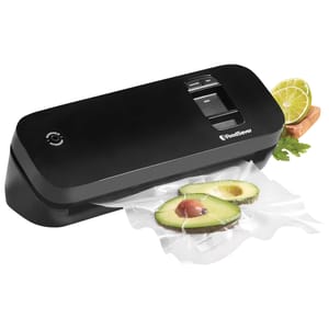 A black FoodSaver vacuum sealer is sealing avocados in plastic bags, with lime and herbs shown nearby, illustrating its use for preserving fresh produce.