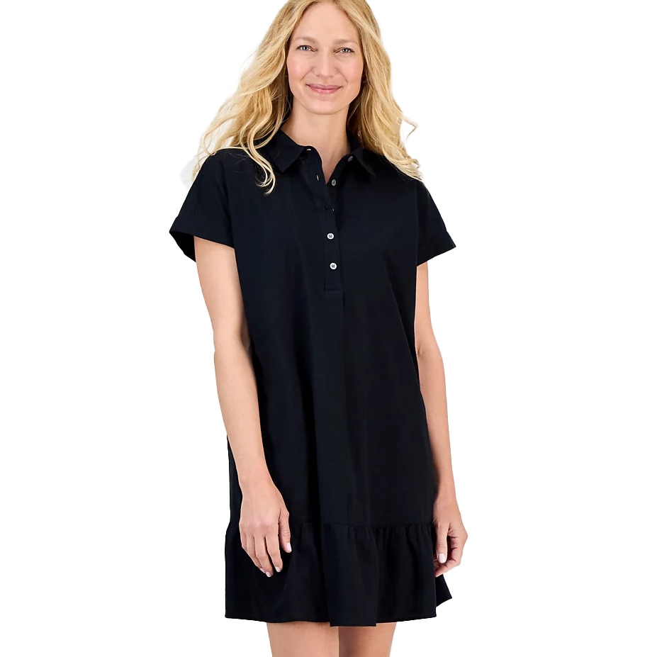 A woman is wearing a short-sleeve, black collared shirt dress with button details and a ruffled hem.
