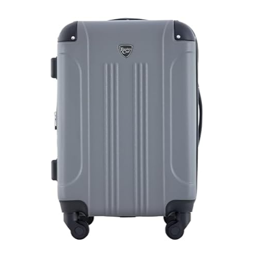 A gray hard-shell suitcase with four spinner wheels and a top handle, featuring a small badge logo on the front.