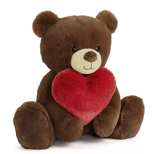 A brown plush teddy bear holding a heart.