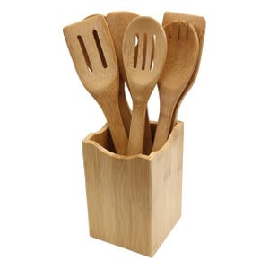 A set of bamboo kitchen utensils including slotted spatulas and spoons, stored in a matching bamboo holder.