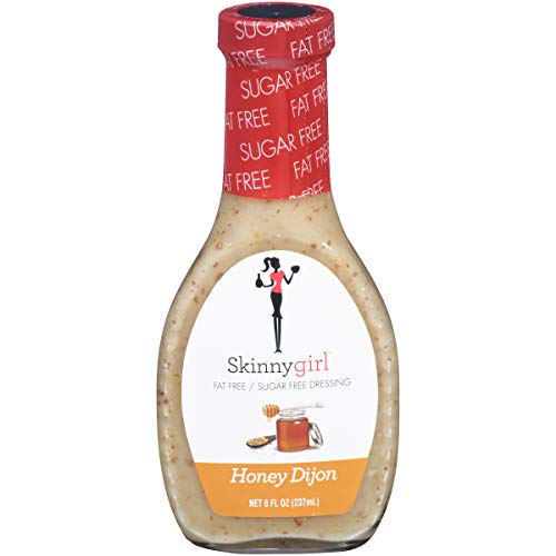 Clear bottle of Skinnygirl Honey Dijon salad dressing, labeled as sugar-free and fat-free, with a graphic of a woman holding a fork.