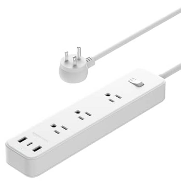 Amazon Basics Power Strip with three AC outlets and two USB ports, featuring a flat plug design suitable for tight spaces, and an on/off switch.
