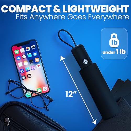 Compact black umbrella (12\“) with glasses and smartphone, showcasing its lightweight design under 1 lb. Suitable for easy carrying in a bag.