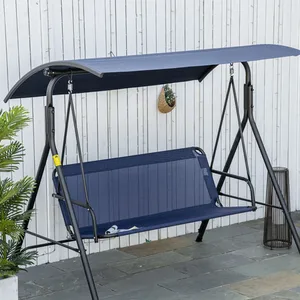 A blue outdoor swing with a canopy, featuring a metal frame, is set against a white fence on a patio.