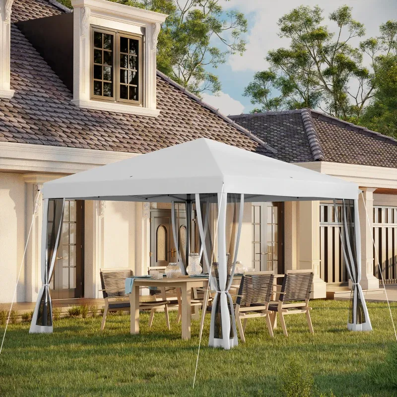 A white canopy tent with clear side panels is set up over a wooden outdoor dining table with chairs on a grassy lawn in front of a house.