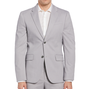 A man is wearing a light gray suit with a white dress shirt. The suit jacket features notched lapels, a two-button closure, and flap pockets.