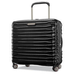 A black hard-shell suitcase with a textured, horizontal ribbed design, featuring four multi-directional spinner wheels and a telescopic handle.