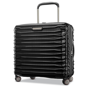 A black hard-shell suitcase with a textured, horizontal ribbed design, featuring four multi-directional spinner wheels and a telescopic handle.