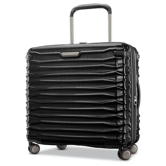 A black hard-shell suitcase with a textured, horizontal ribbed design, featuring four multi-directional spinner wheels and a telescopic handle.