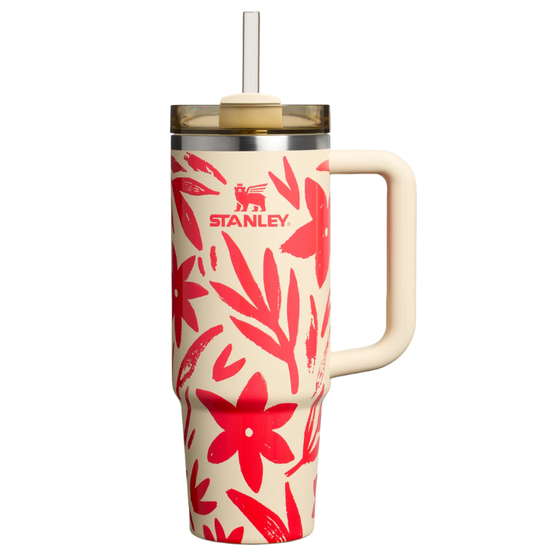 Stanley Quencher H2.0 FlowState Tumbler featuring a beige background with red floral patterns, a large handle, and lid with a straw, part of the Mother's Day Collection.