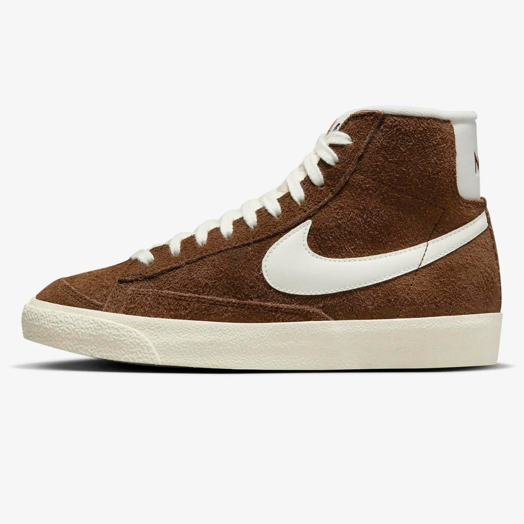 A brown high-top sneaker with a white swoosh logo and cream sole.