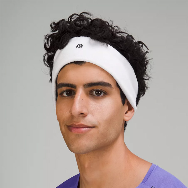 A man wearing a white sports headband.