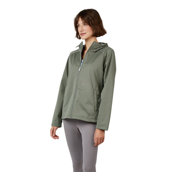 A woman wearing a green hooded jacket, gray capri leggings, and white sneakers stands in a relaxed pose against a neutral background.