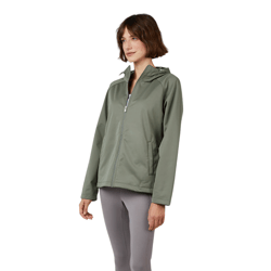 A woman wearing a green hooded jacket, gray capri leggings, and white sneakers stands in a relaxed pose against a neutral background.