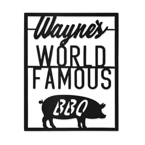 Black metal wall sign with \“Wayne's World Famous BBQ\“ text, featuring a silhouette of a pig.