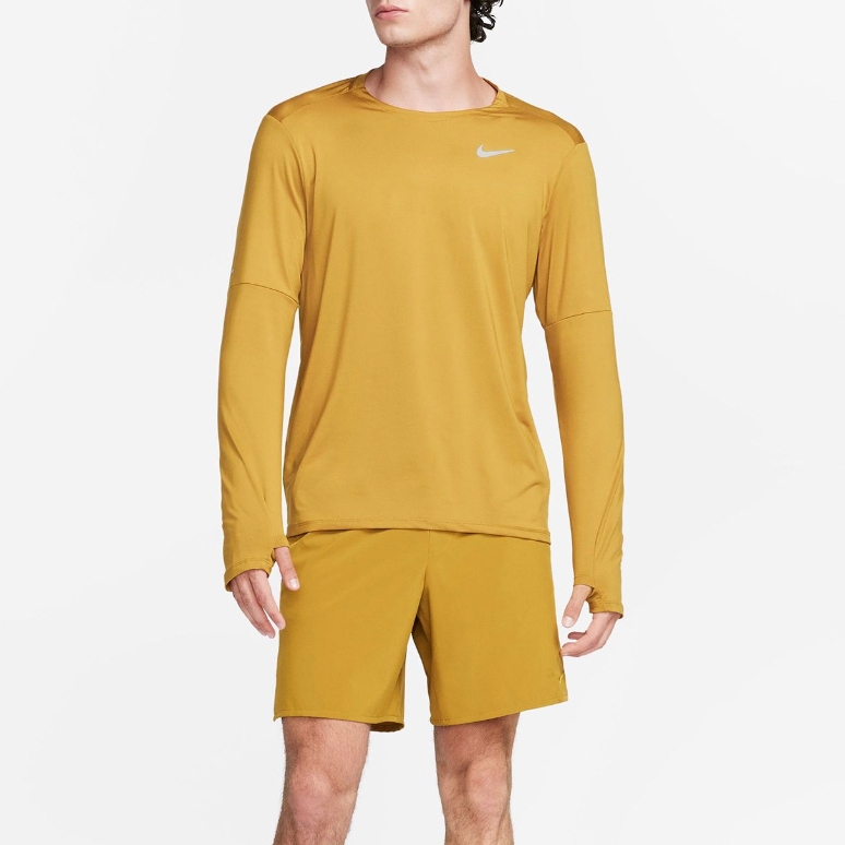 A mustard yellow long-sleeve athletic shirt paired with matching shorts, both bearing a small white logo on the front.
