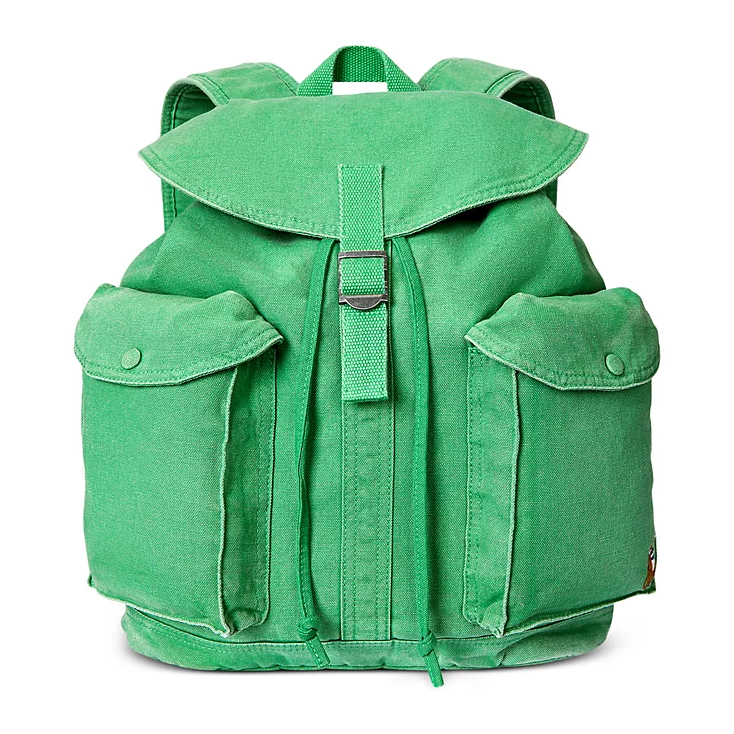 A green canvas backpack with two front pockets, a flap cover, and a buckle closure.