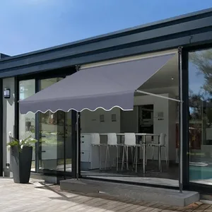 A retractable grey outdoor awning is installed above a patio door, providing shade to the patio area.