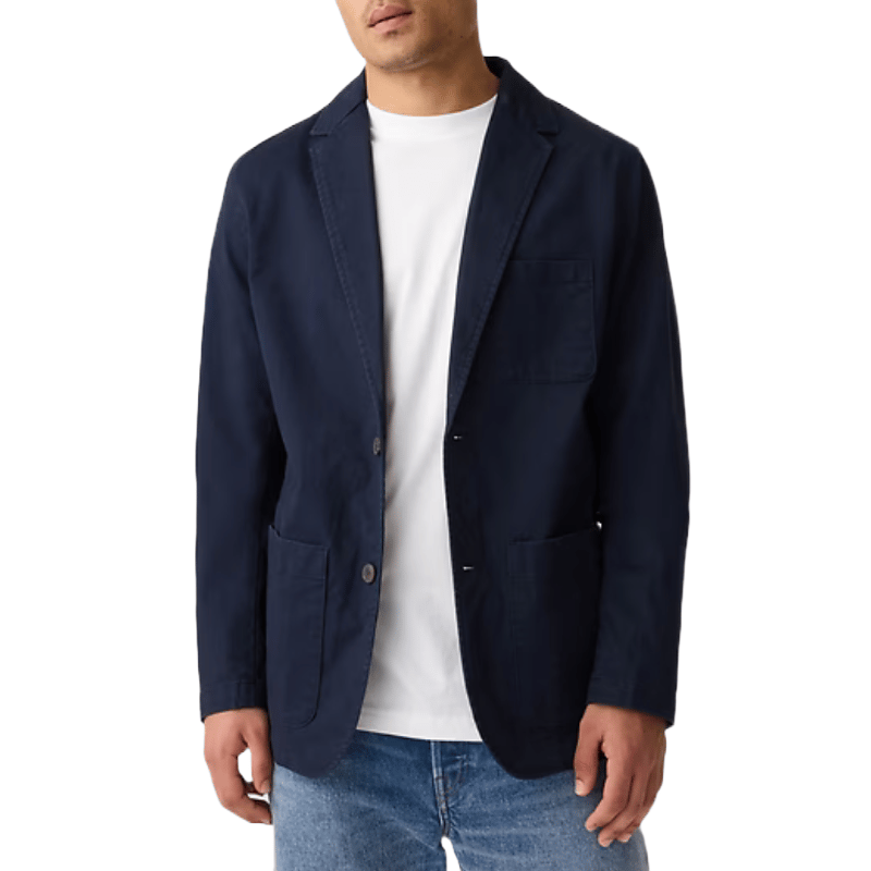 Navy twill blazer with a classic design, featuring notch lapels, two-button closure, and three patch pockets, worn over a white T-shirt and paired with blue jeans.