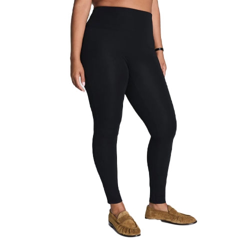 A person is wearing black leggings and brown moccasins, with a focus on showcasing the clothing items.