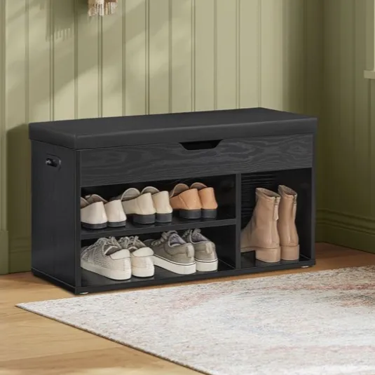 VASAGLE home entryway features a black shoe bench with multiple shelves for shoe storage and a cushioned seat, alongside a wall coat rack with a hat and scarf hanging.