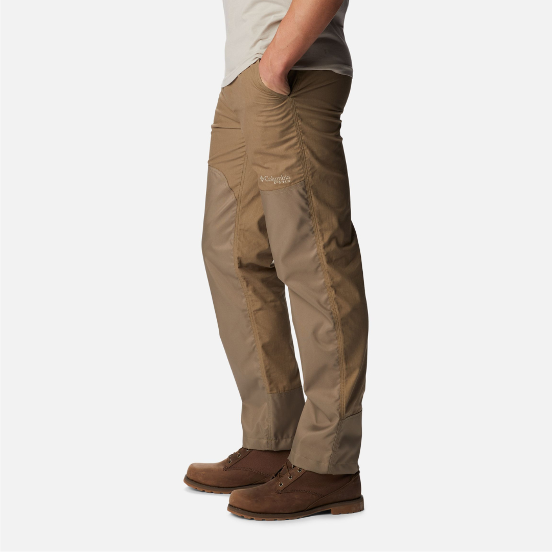 A person wearing khaki outdoor pants and brown leather shoes.