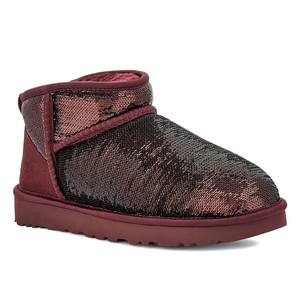 UGG Mini Mirror Ball Cozy Boots feature a shiny maroon sequin exterior with a plush interior lining and a flat sole for comfort and warmth.