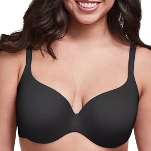 A woman wearing a black, seamless, lightly padded bra with adjustable straps.