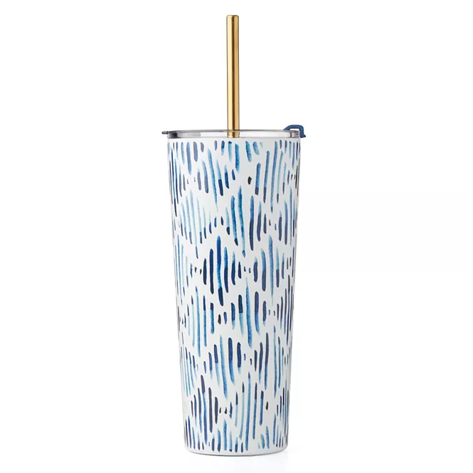 A tall, patterned tumbler with a metallic gold straw and a sliding closure lid.