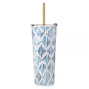A tall, patterned tumbler with a metallic gold straw and a sliding closure lid.