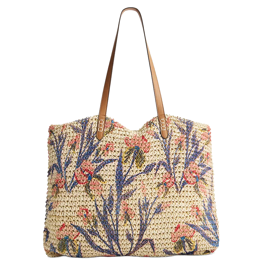 Woven tote bag with floral embroidery in blue, pink, and green, featuring brown leather straps.