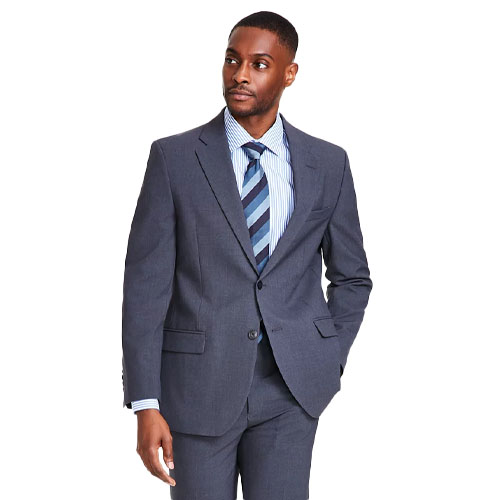 A man in a dark gray suit with a striped blue and white shirt and a blue striped tie.