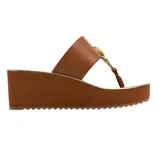Brown wedge sandal featuring a wide strap with a decorative gold ring and a thong-style toe strap.