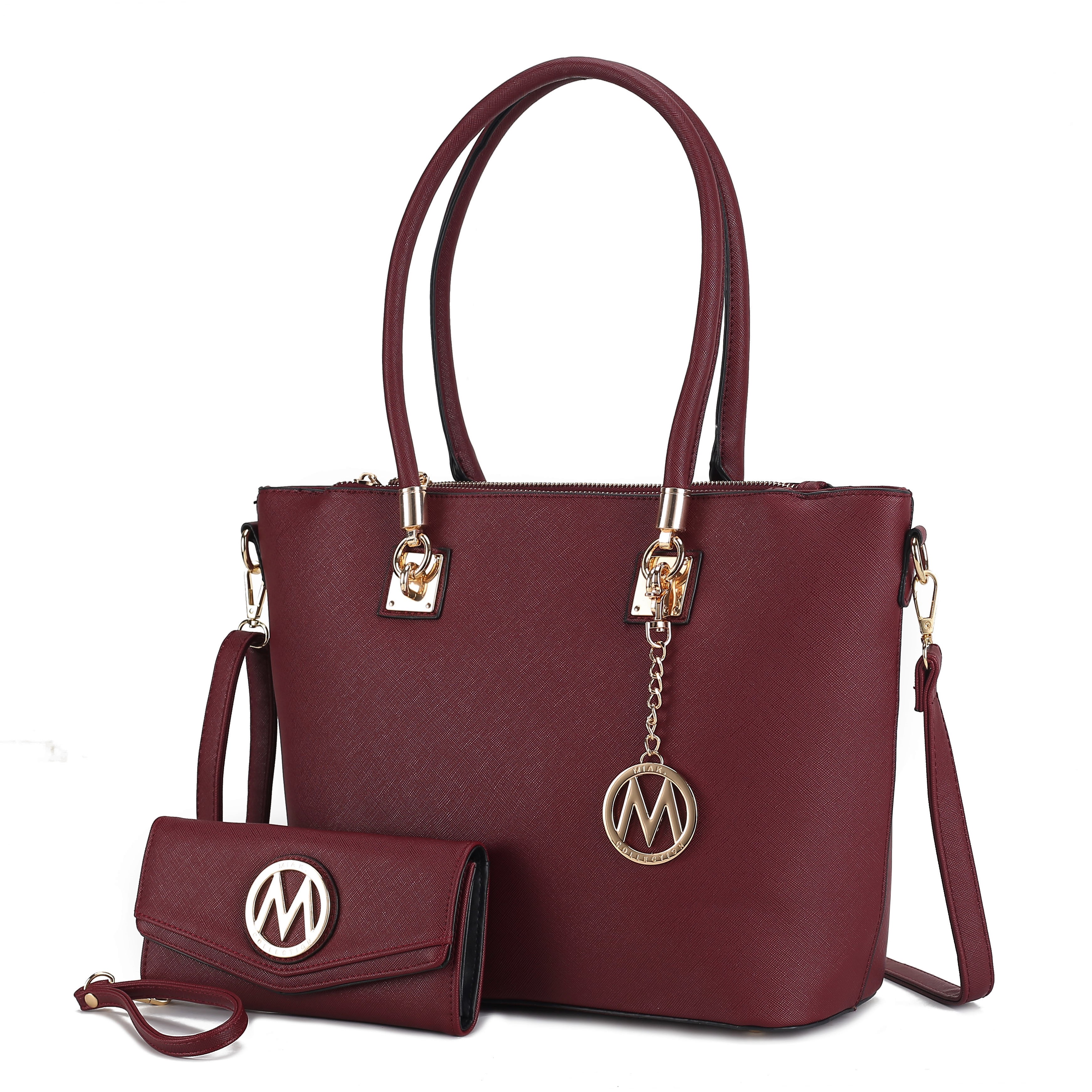 A burgundy MKF tote with gold accents, featuring double handles, a detachable shoulder strap, and a logo charm. Includes a matching wallet with a wrist strap and logo emblem.
