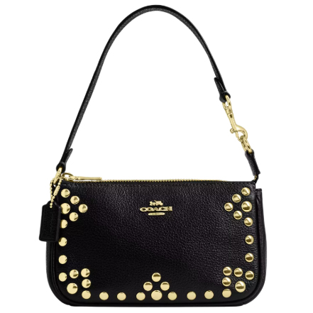 A black Coach Outlet Nolita bag with gold-tone studs accenting the front, featuring a detachable leather strap and gold hardware. The Coach logo is prominently displayed on the front.
