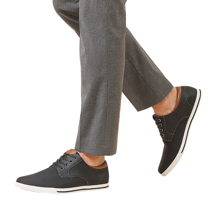Men's fashion sneakers with a black design and white soles. Paired with gray pants, showcasing a smart and stylish look.