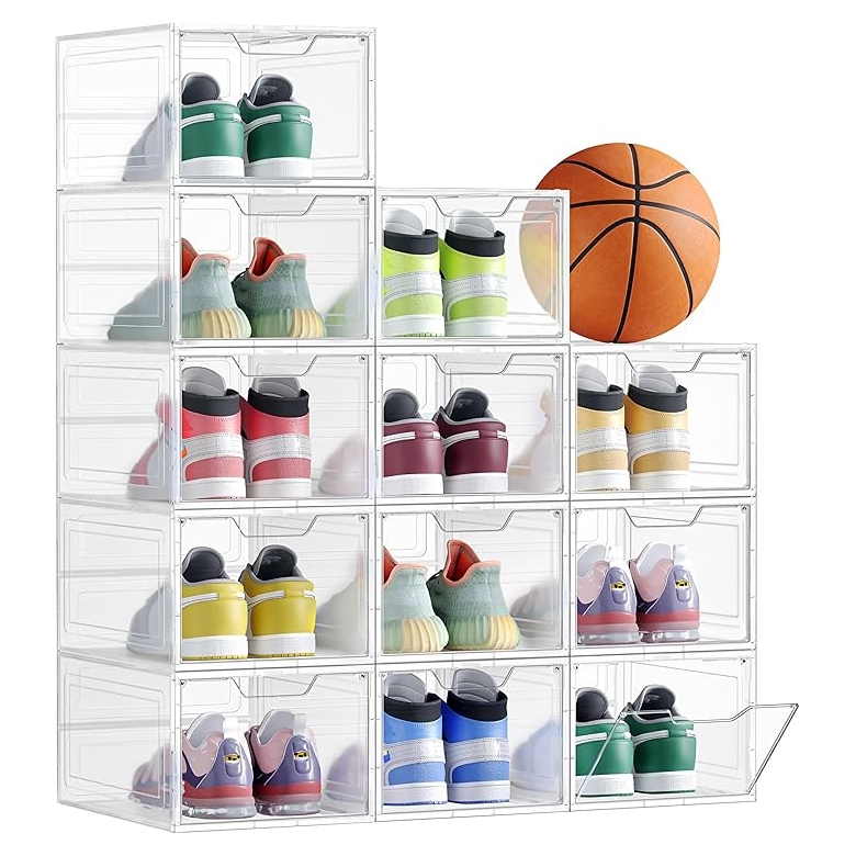 A stack of transparent shoe storage boxes neatly organizes various pairs of colorful sneakers, with a basketball positioned beside them.