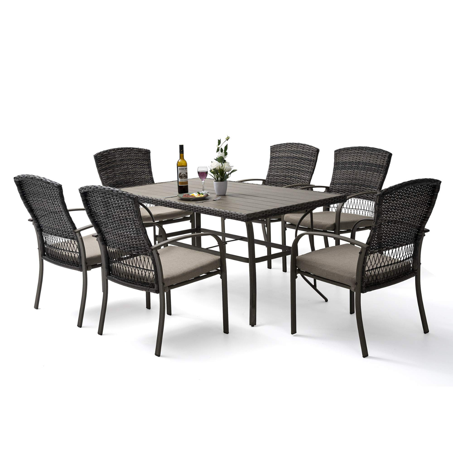 A 7-piece dining set featuring a rectangular table and six wicker chairs with cushioned seats. The table has a sleek design with a bottle of wine and flowers as decor. It is suitable for outdoor settings.