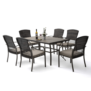A 7-piece dining set featuring a rectangular table and six wicker chairs with cushioned seats. The table has a sleek design with a bottle of wine and flowers as decor. It is suitable for outdoor settings.