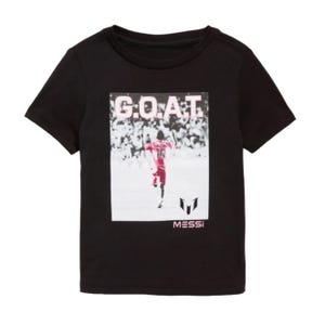 Black T-shirt featuring a soccer player with the number 10, the word \“G.O.A.T.\“ in large letters above, and \“Messi\“ below, along with a logo.