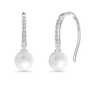 Dangling earrings feature a round pearl with a sleek hook design, adorned with a row of small sparkling crystals.