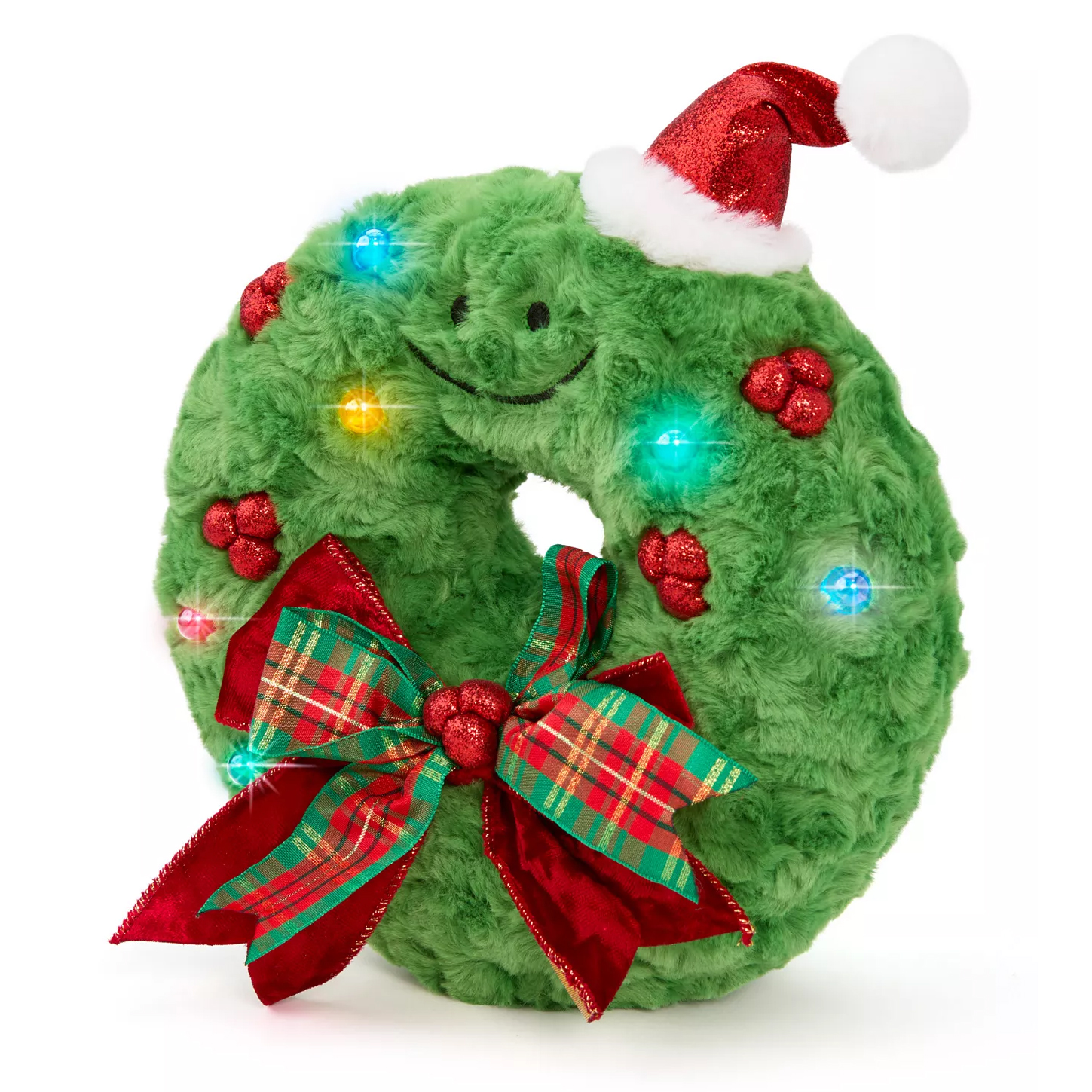 A plush green wreath with a smiling face, wearing a Santa hat, adorned with red glittery decorations and a plaid bow, featuring colorful lights.