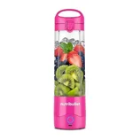 A pink NutriBullet portable blender filled with ice, strawberries, blueberries, kiwi slices, and mint leaves.