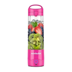 A pink NutriBullet portable blender filled with ice, strawberries, blueberries, kiwi slices, and mint leaves.