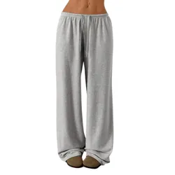 Grey wide-legged sweatpants with an elastic waistband, paired with a white cropped top and slippers.