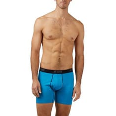 A male model wearing bright blue boxer briefs with a black waistband labeled \“32 COOL.\“