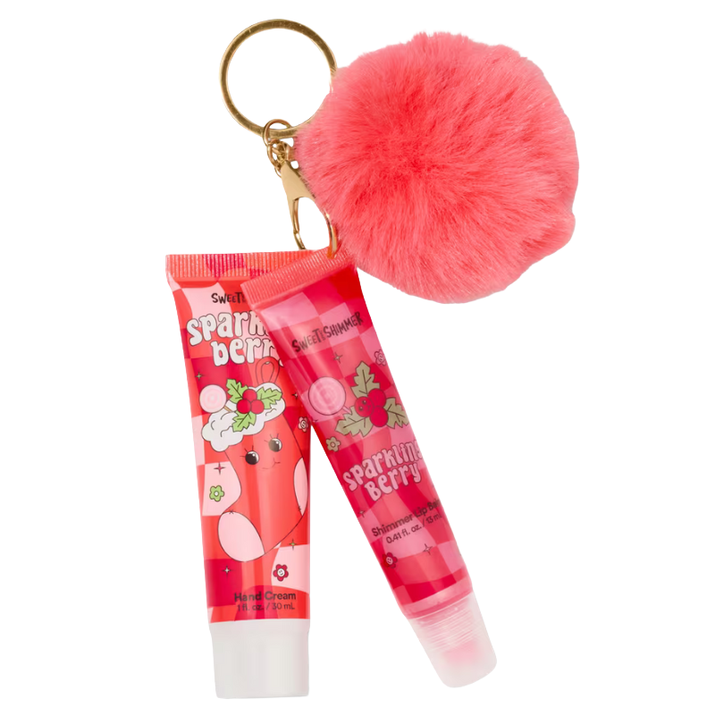 A set includes Sweet Shimmer \“Sparkling Berry\“ hand cream and shimmer lip gloss, accompanied by a pink fluffy pom-pom keychain.